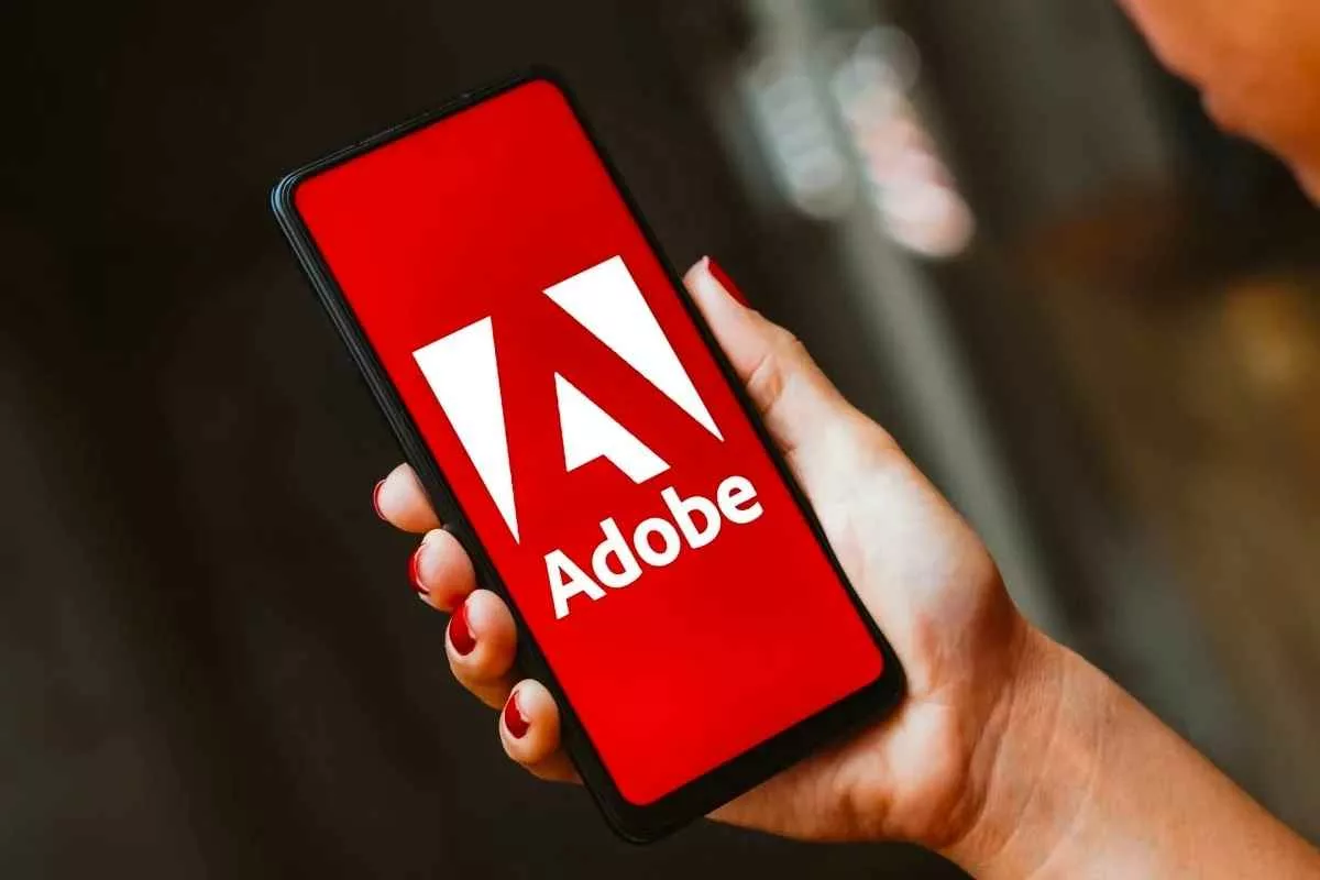 adobe-company-logo-smartphone-woman-hand_11zon